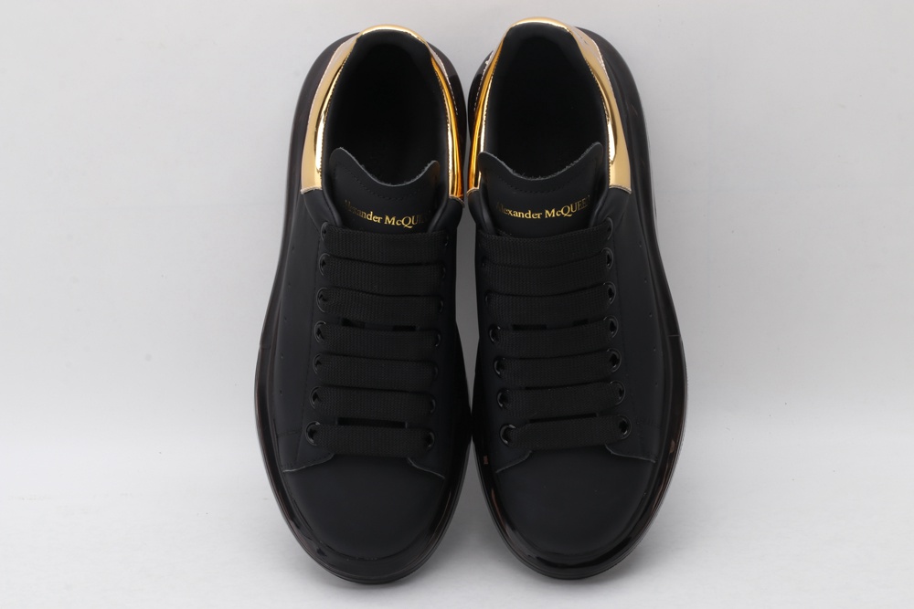 AMQ black oversized sneakers with gold heel