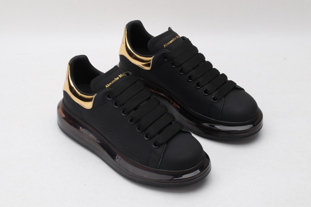 AMQ black oversized sneakers with gold heel