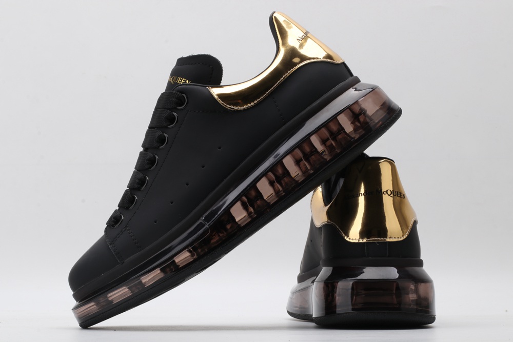 AMQ black oversized sneakers with gold heel