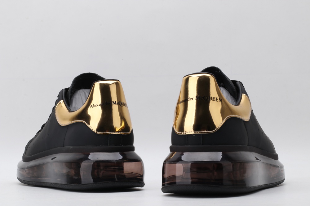 AMQ black oversized sneakers with gold heel