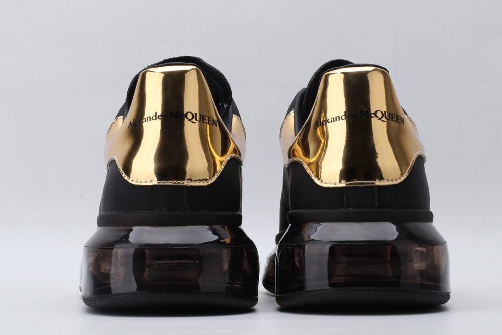 AMQ black oversized sneakers with gold heel