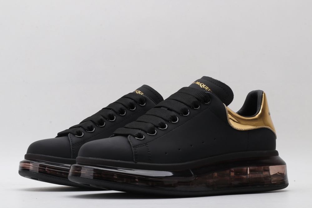 AMQ black oversized sneakers with gold heel