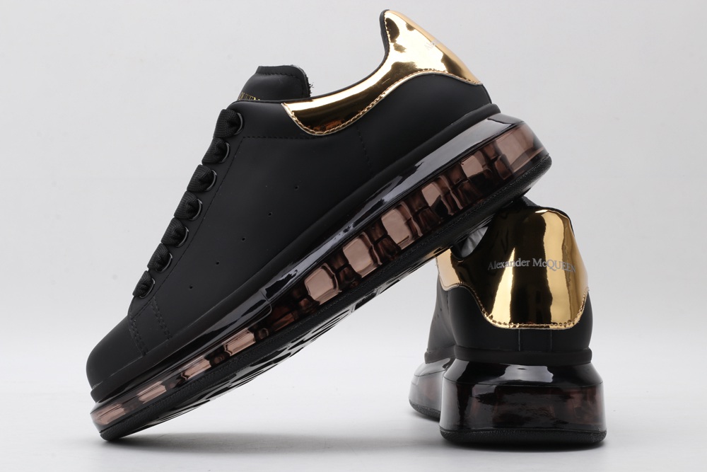 AMQ oversized sneakers black with gold heel