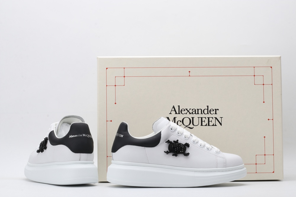 AMQ white oversized sneakers with black heel