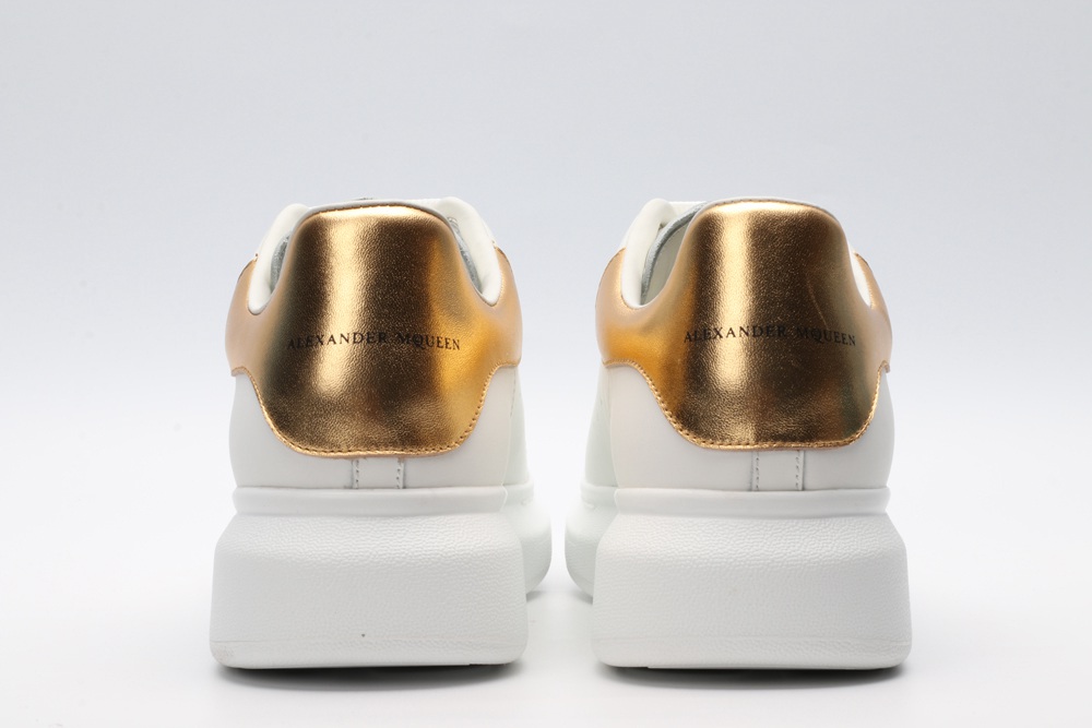 AMQ OVERSIZED SNEAKER with gold grain leather heel