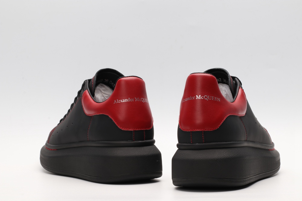 AMQ black oversized sneakers with red heel