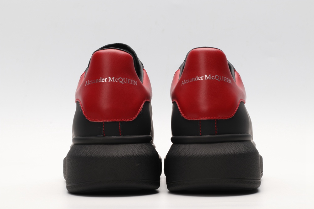 AMQ black oversized sneakers with red heel