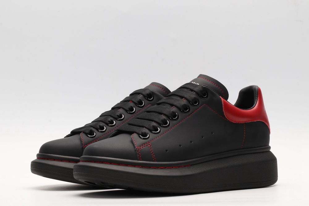 AMQ black oversized sneakers with red heel