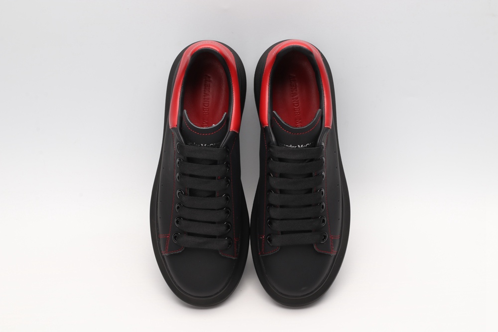 AMQ black oversized sneakers with red heel
